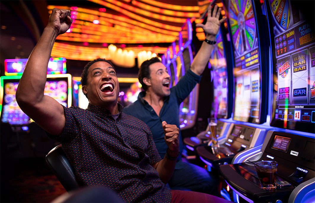 people celebrating playing slots and winning