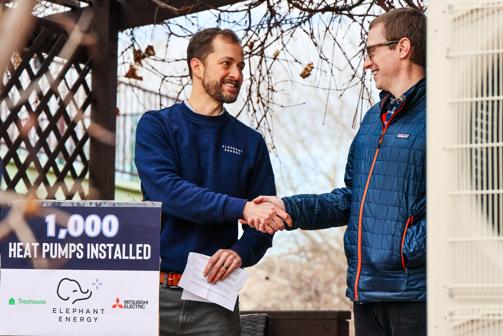 DR Richardson, Co-founder of Elephant Energy, shaking hands with Justin Bailey, Lafayette Homeowner