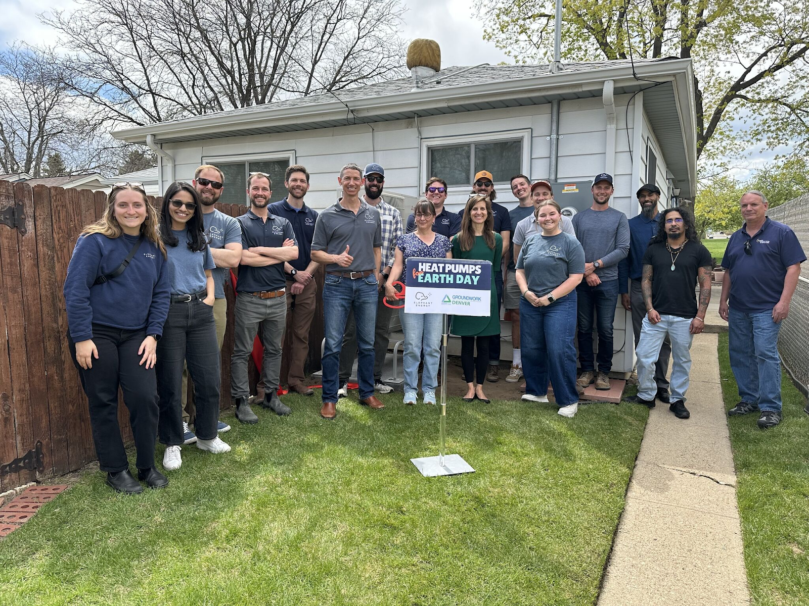 Photo of the Elephant Energy and Groundwork Denver team around a podium celebrating Earth Day