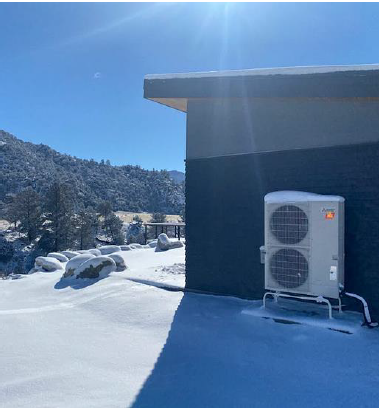 Mitsubishi heat pump condenser in the snow