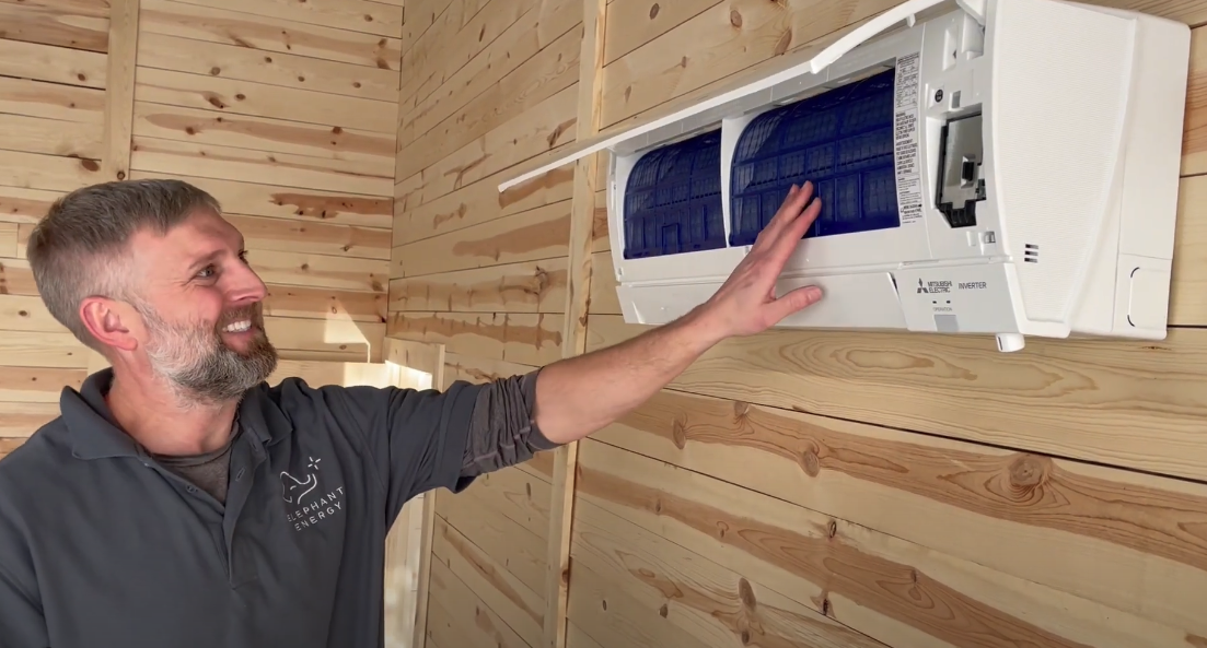 Elephant Energy technician checking a heat pump filter