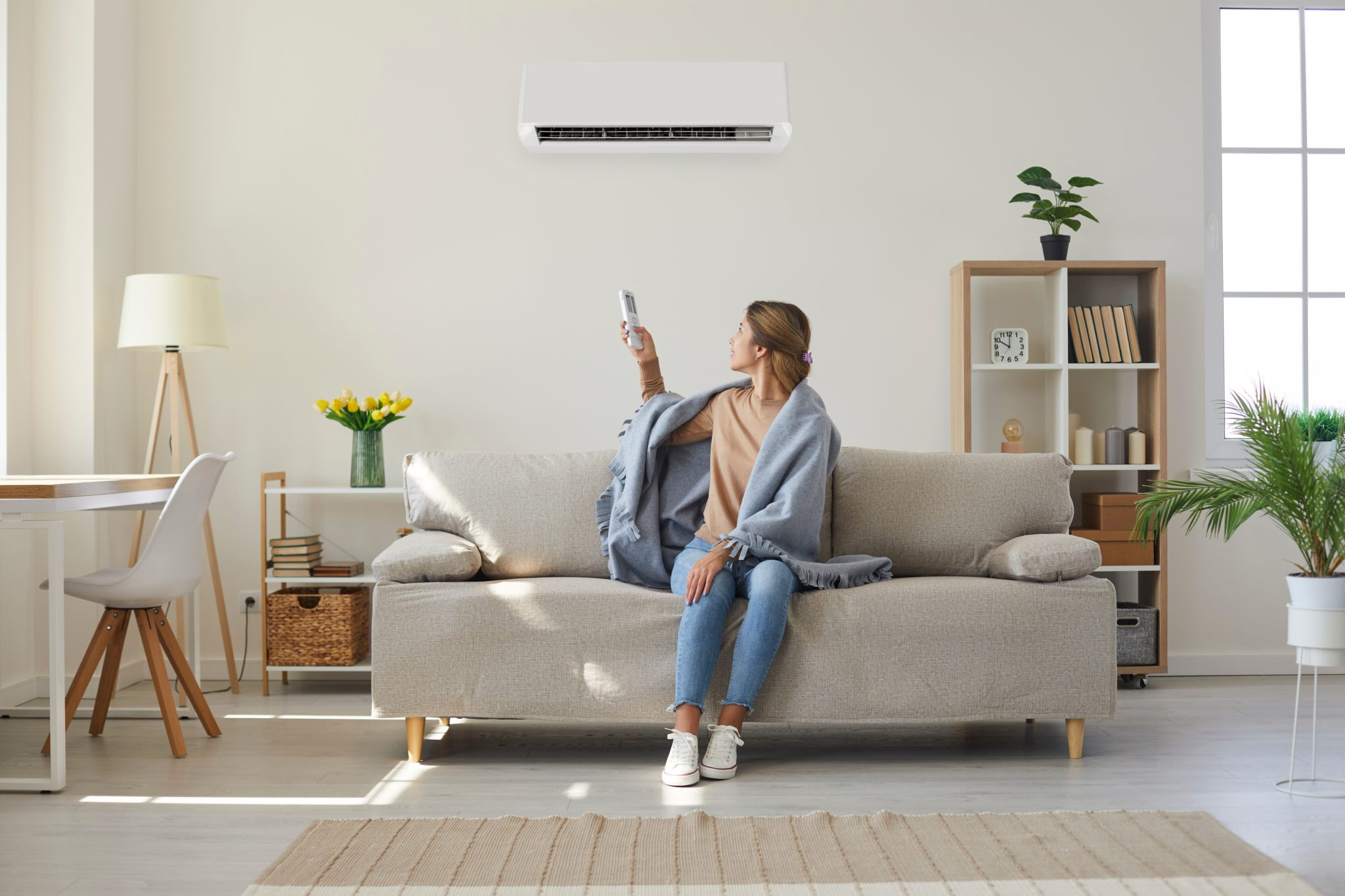 Woman turning on her heat pump in the living room