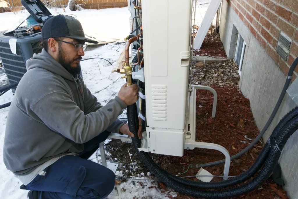 Technician installing a heat pump
