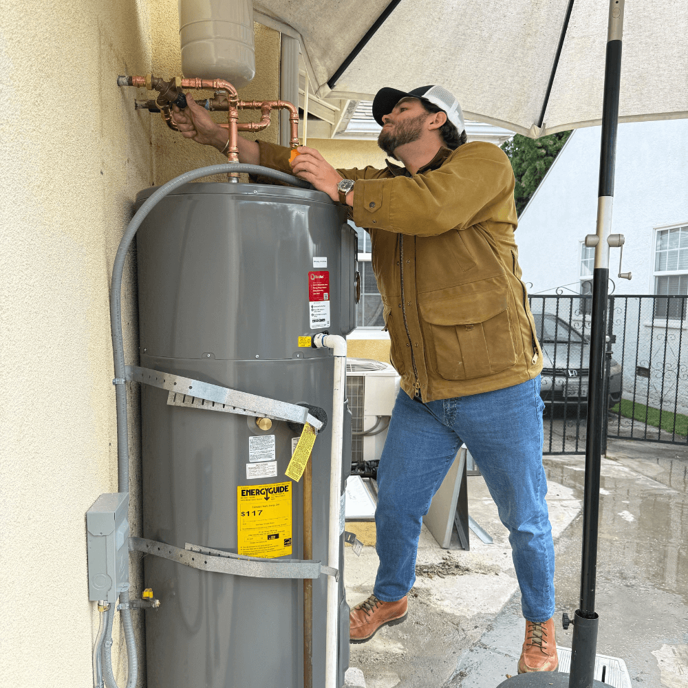 Elephant energy team inspecting heat pump water heater