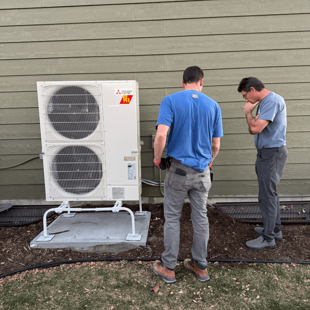 Elephant energy team inspecting heat pump