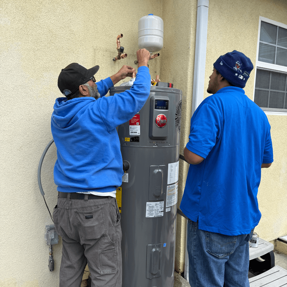 Elephant energy team installing heat pump water heater
