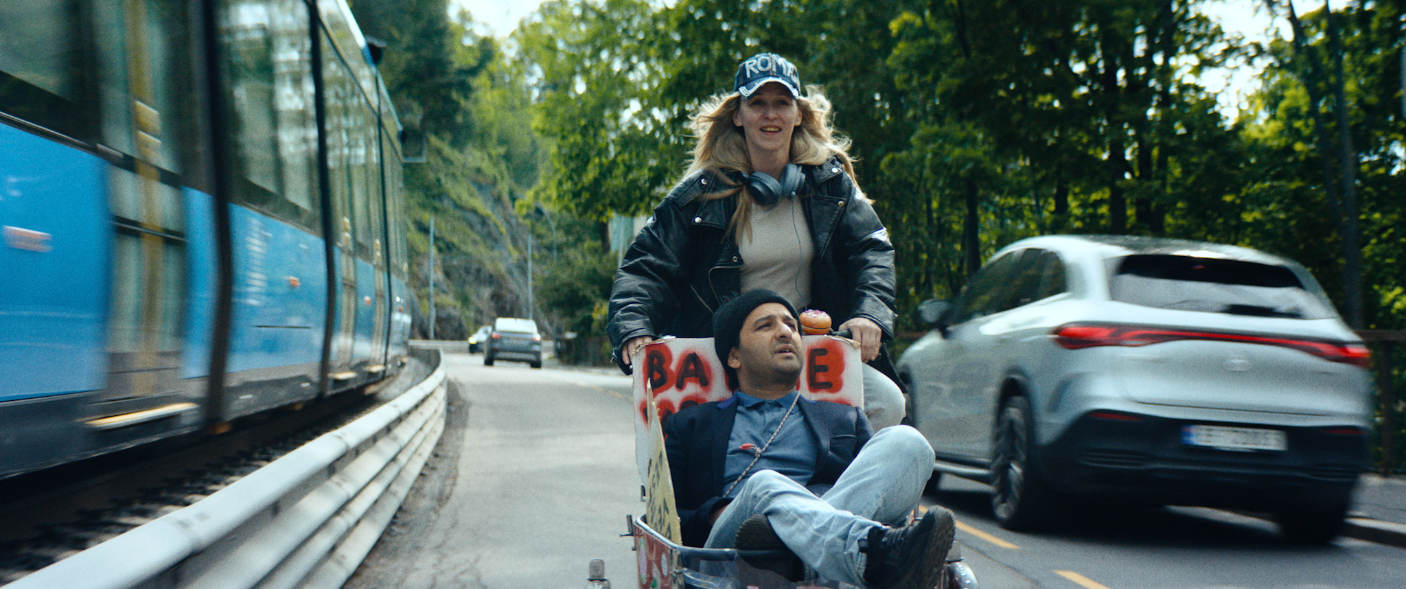 Bildet er fra filmen Agnes mot verden der Marie Blokhus  og Nader Khademi spilte hovedrollene. På bildet ser vi en trikk og at Agnes (Marie) triller Hansi nedover en vei i en handlevogn.