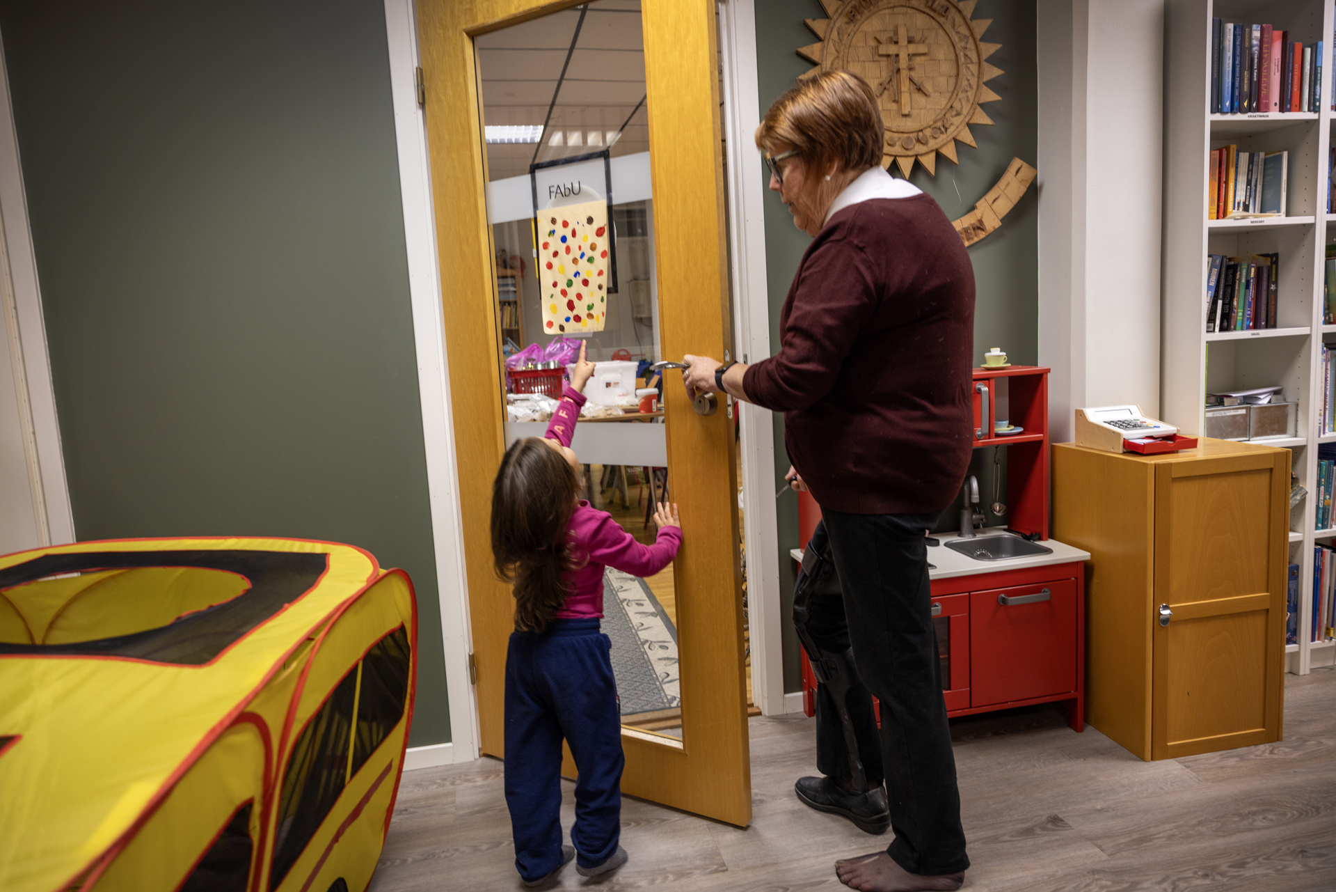 Foto: Det første bildet viser en liten jente som løper i en stor sal. Den neste viser samme jenta som leier en voksen dame fra Frelsesarmeen i hånden.