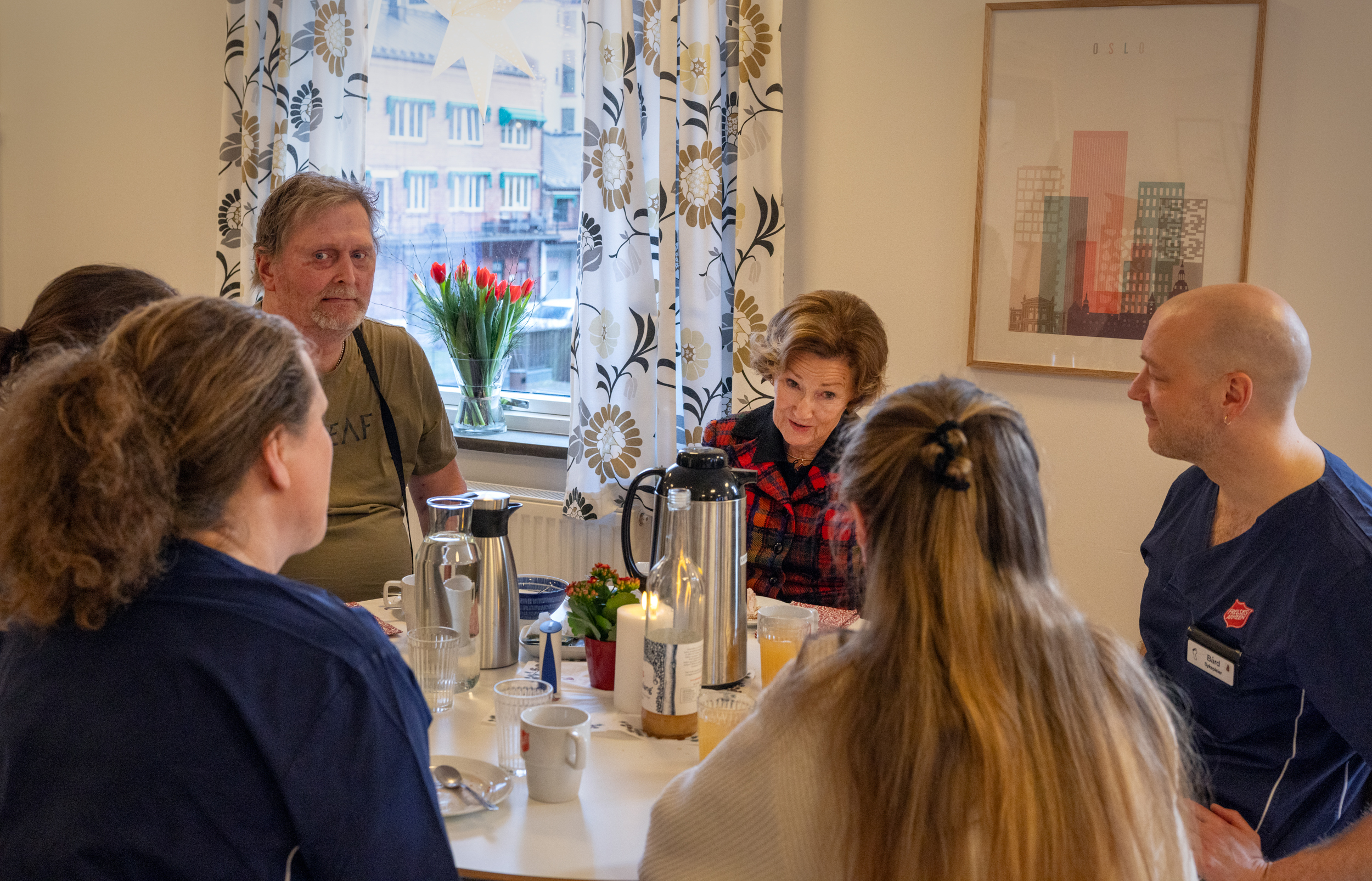 Foto: Dronningen til bords med ansatte og pasienter ved Gatehospitalet.