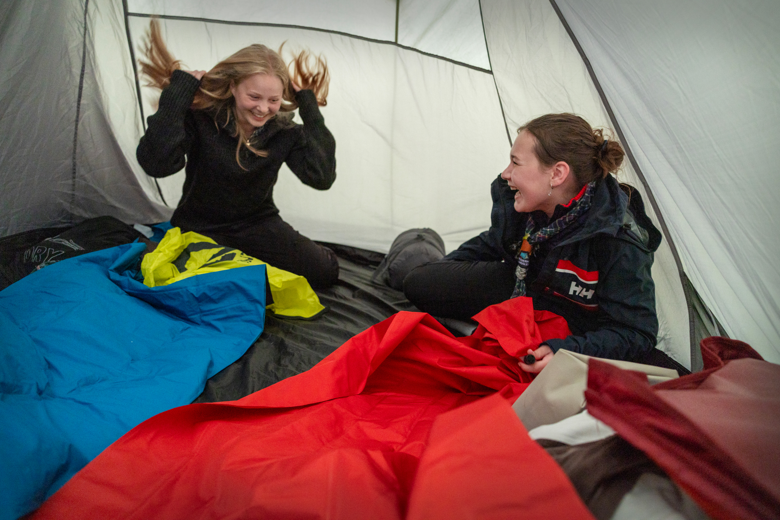 Foto: To jenter men hver sin sovepose inni et telt.