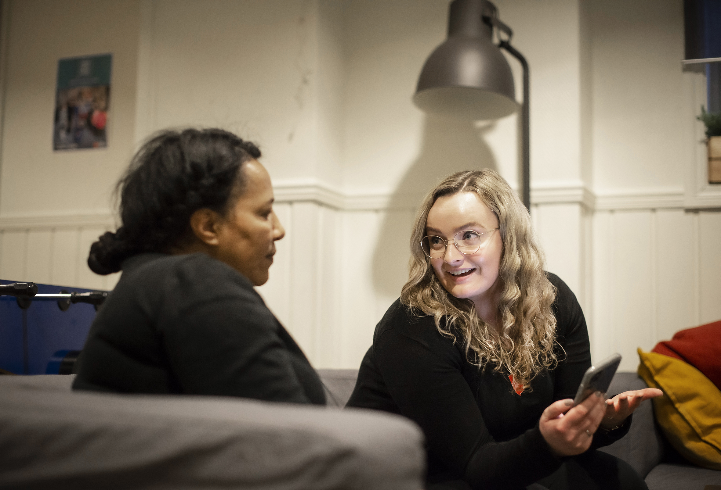 Prosjektleder i ALLEMED sitter i sofaen og snakker med en forelder