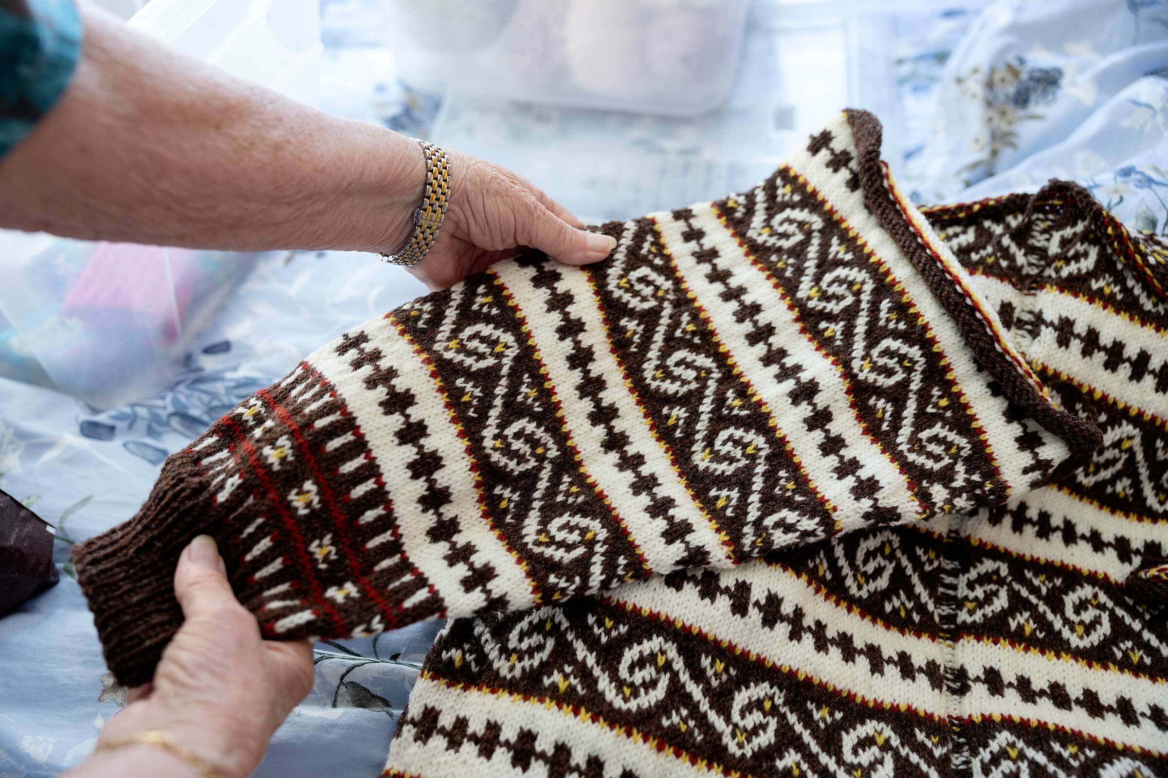 Stikket kofte med border i tradisjonelt mønster.