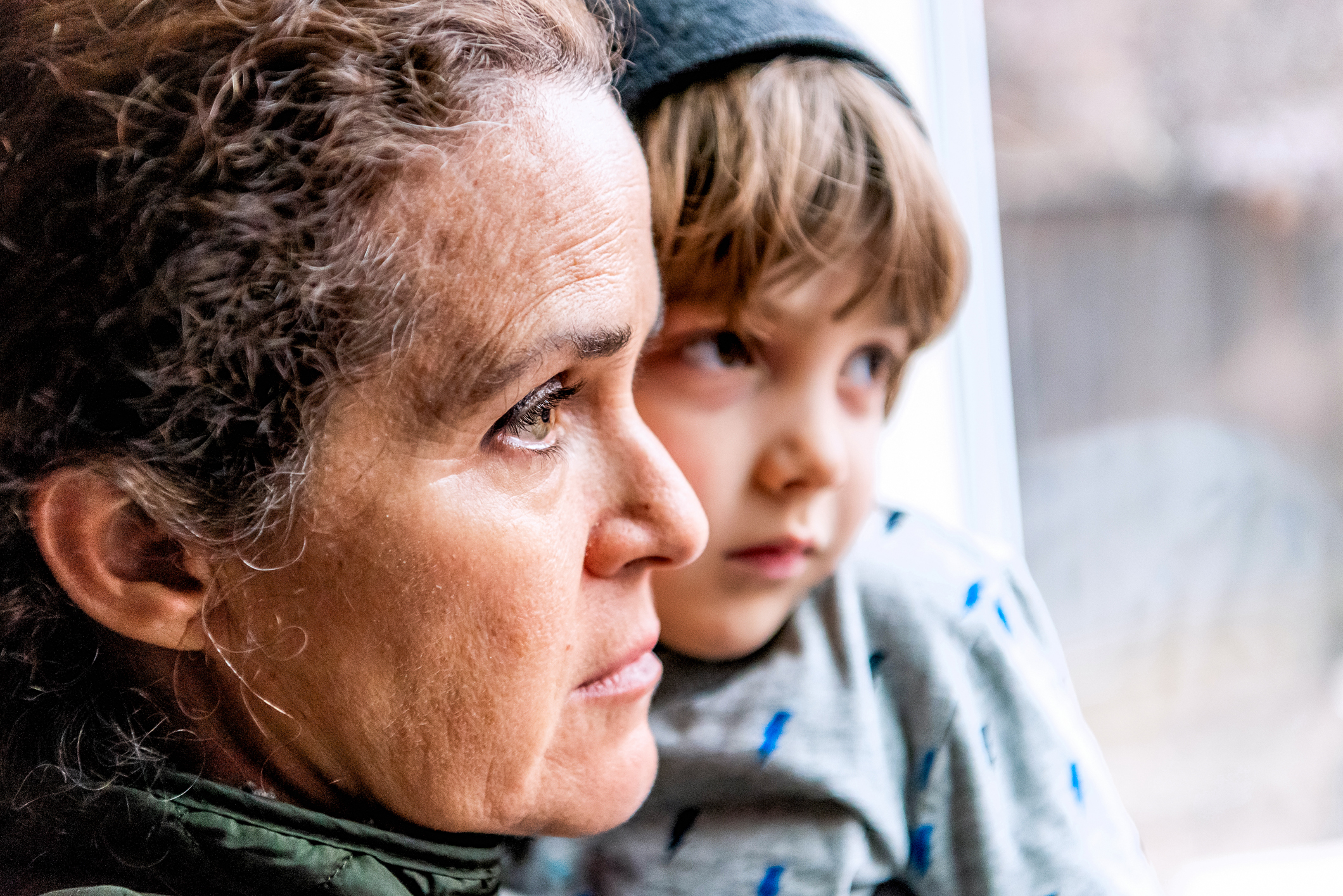 Mor og barn ser ut av et vindu