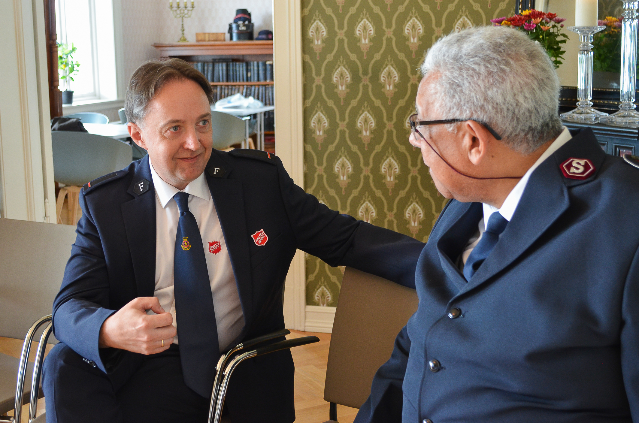 To menn i blå uniform i dyp samtale.