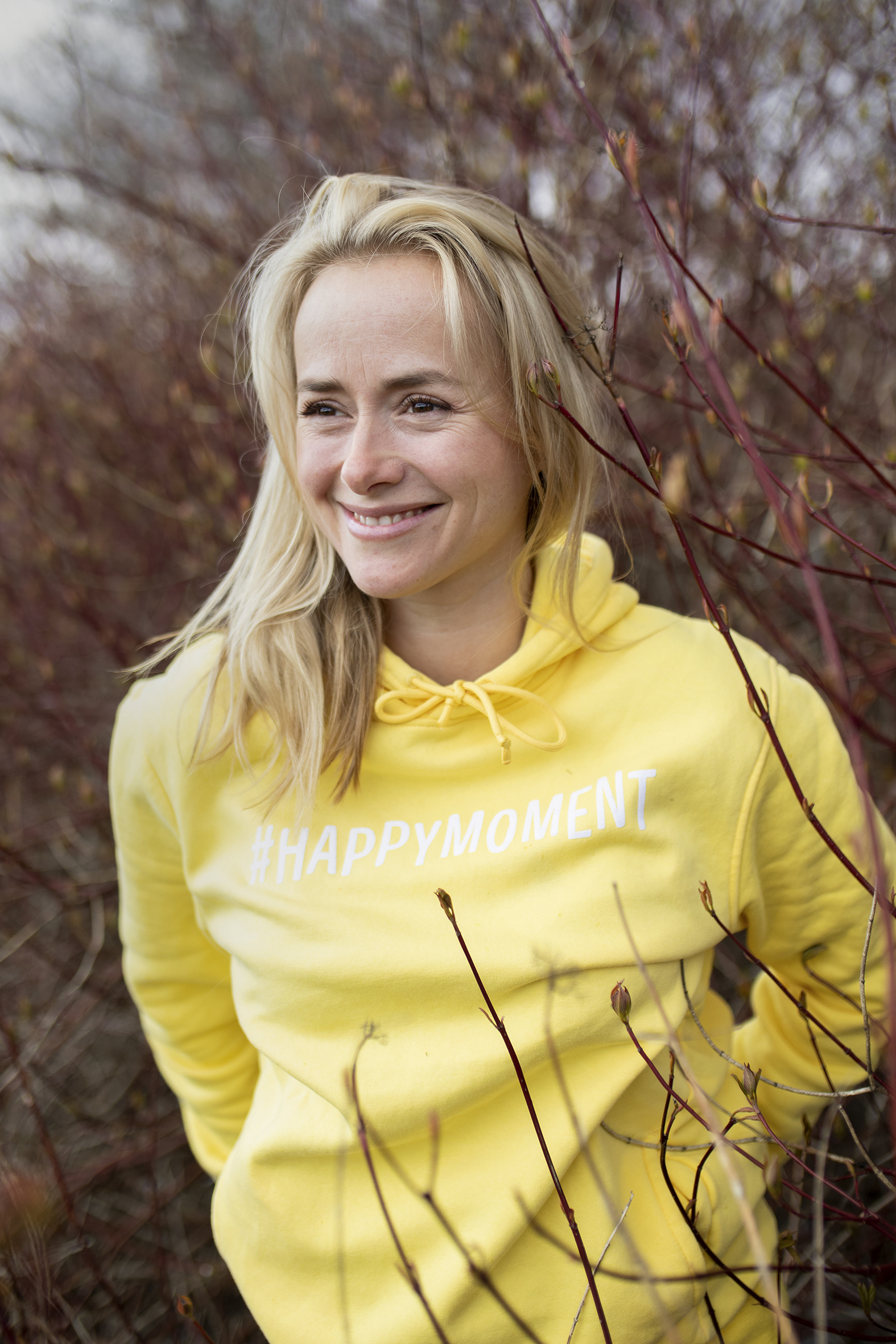 Helsesista smilende i gul hettegenser