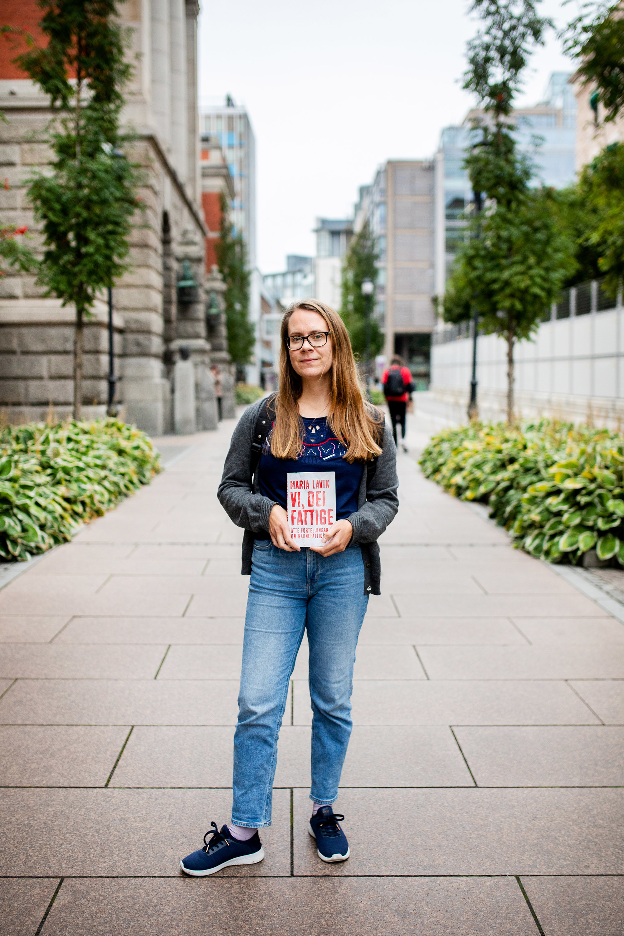 Maria Lavik står på gata i Oslo sentrum og holder frem boken sin