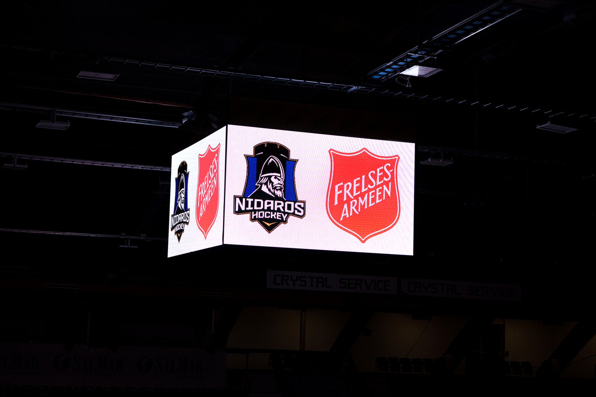 Foto: To bilder etter hverandre, der det første viser kvinne og mann som sitter på hver sin stol inne på et kontoret. Over vinduet henger det flere drakter. Det andre viser et stort skilt som henger oppe under taket i ishallen. Der lyser logoen til Nidaros Hockey og Frelsesarmeen.