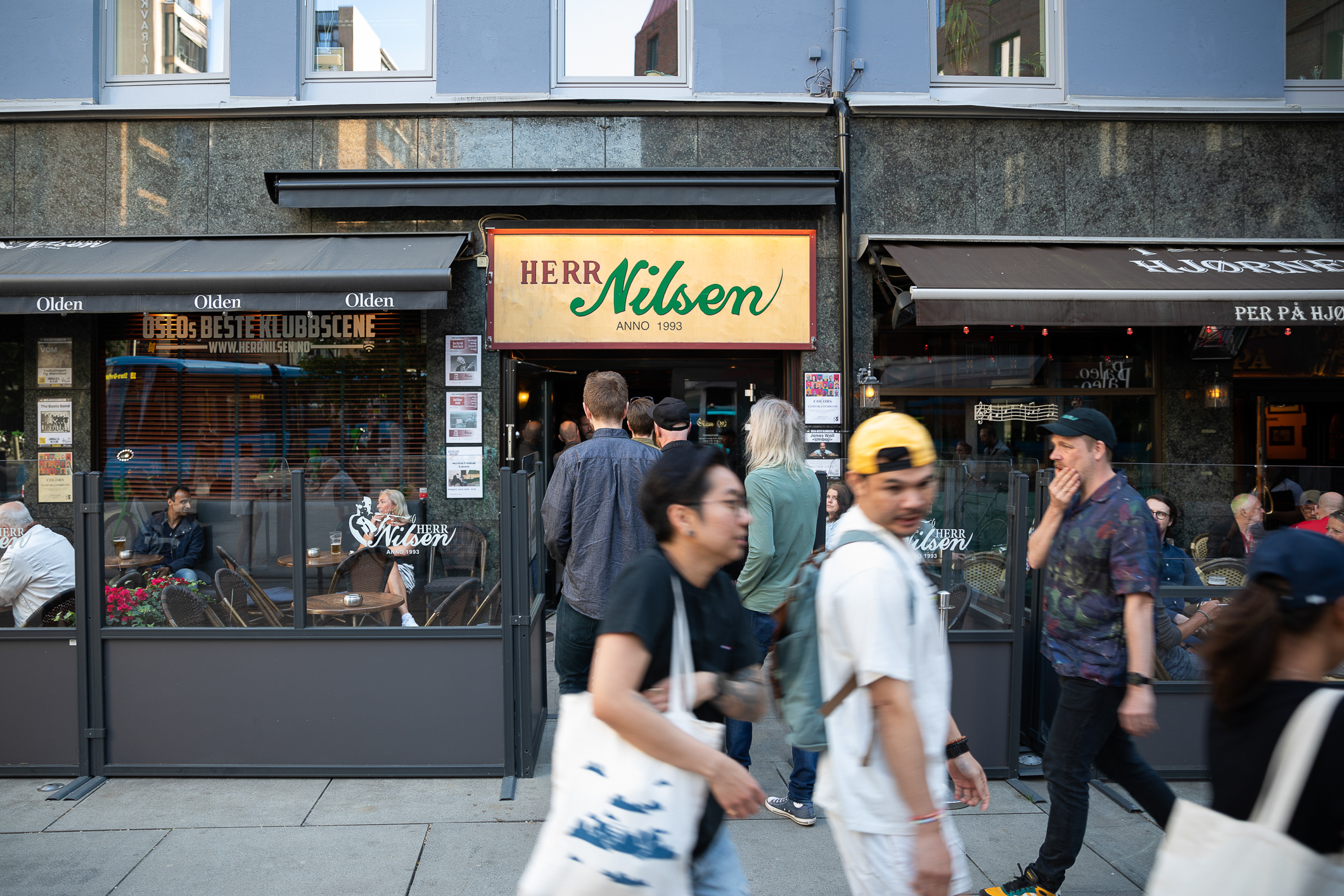 Utsiden av puben Herr Nilsen fotografert i dagslys. Folk går forbi på gaten.