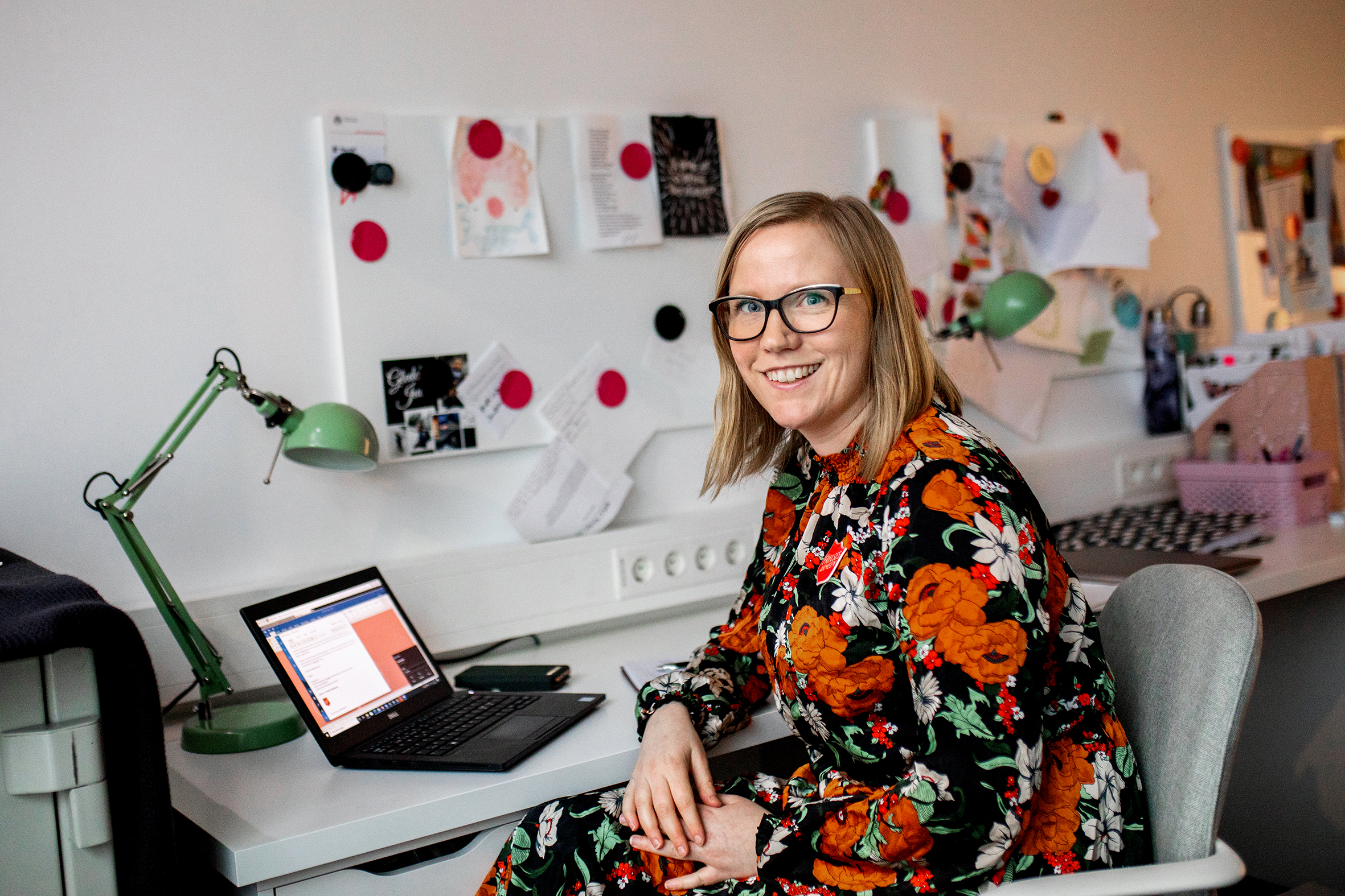 Heidi Goodreid i blomstrende kjole foran pc