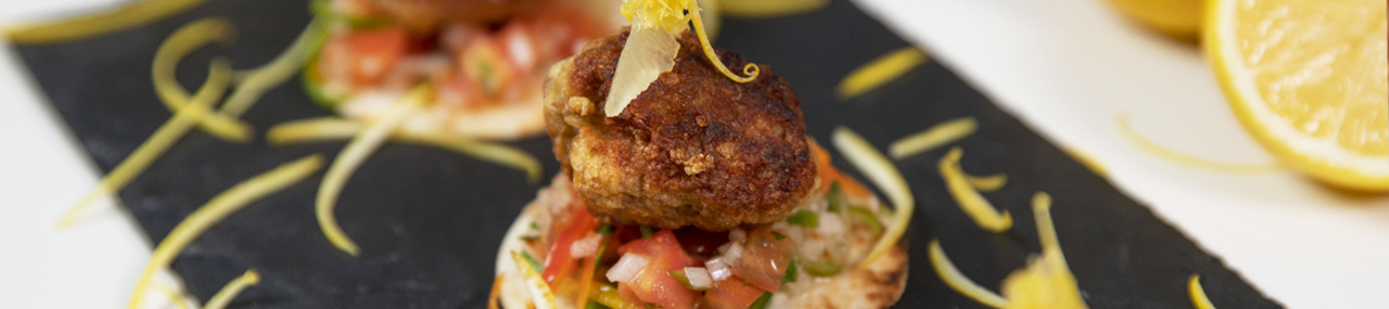LEMON CHICKEN TSUKUNE TOSTADA WITH SHISHITO PEPPERS AND SHICHIMI SALSA