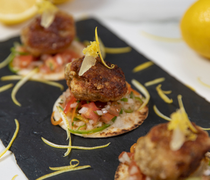 LEMON CHICKEN TSUKUNE TOSTADA WITH SHISHITO PEPPERS AND SHICHIMI SALSA