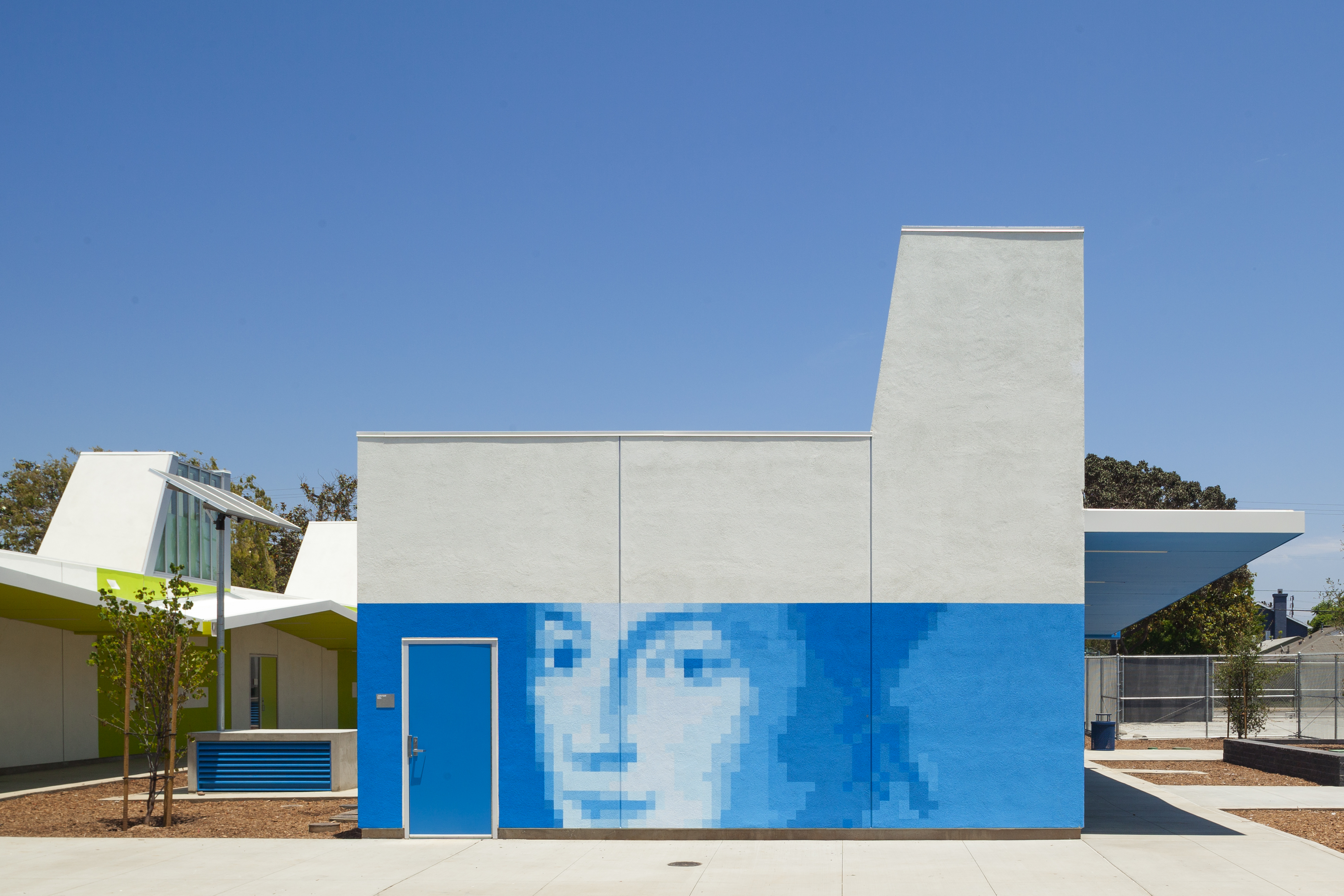 Photo of the painted exterior of John Adams Middle School, featuring a pixelated-style portrait of Abigail Adams.
