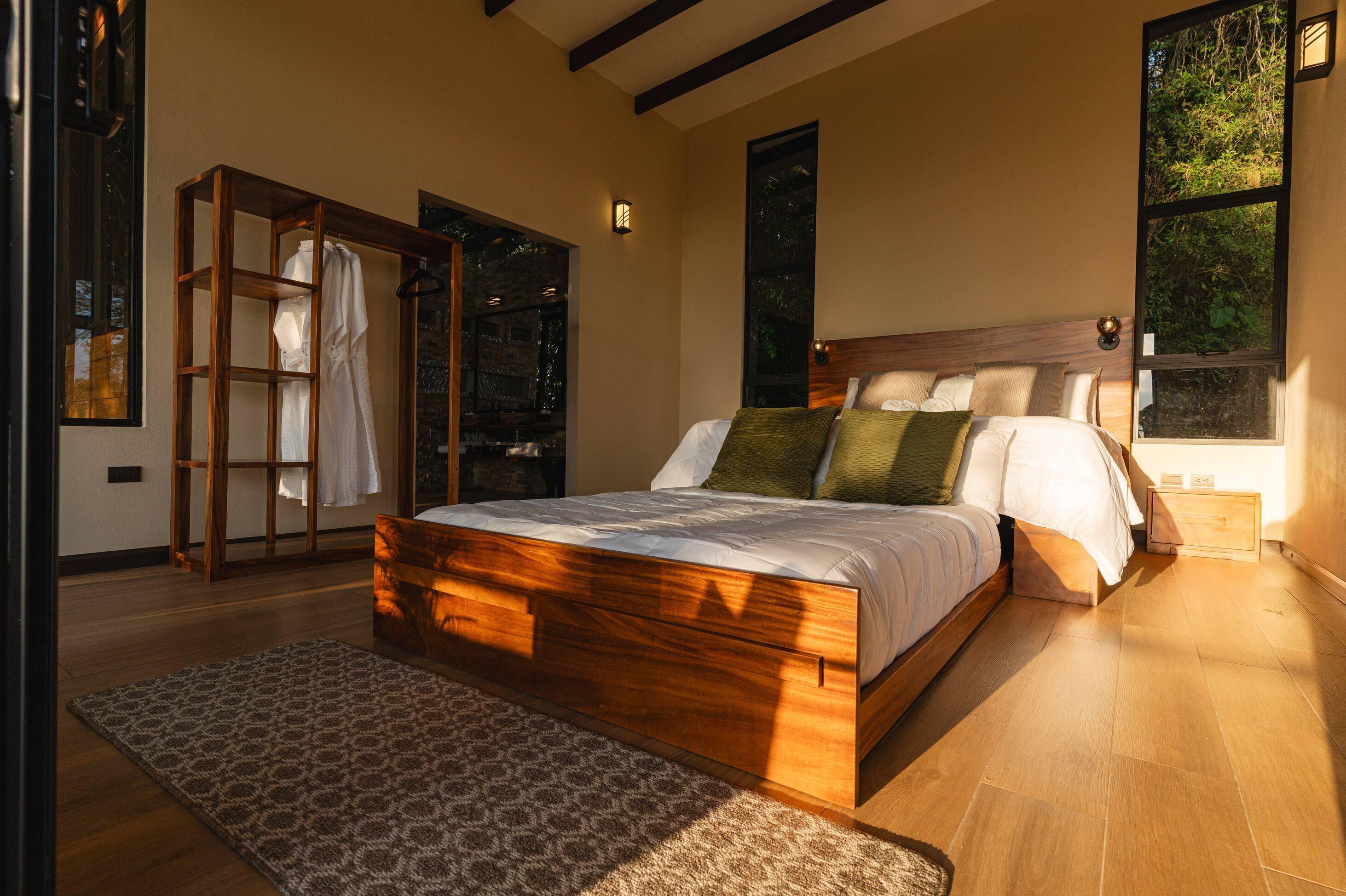 Image of a large, warm-toned bedroom with shadows