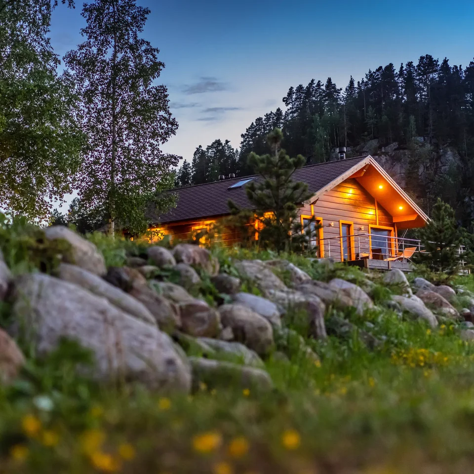 Wooden cabin among trees at dusk