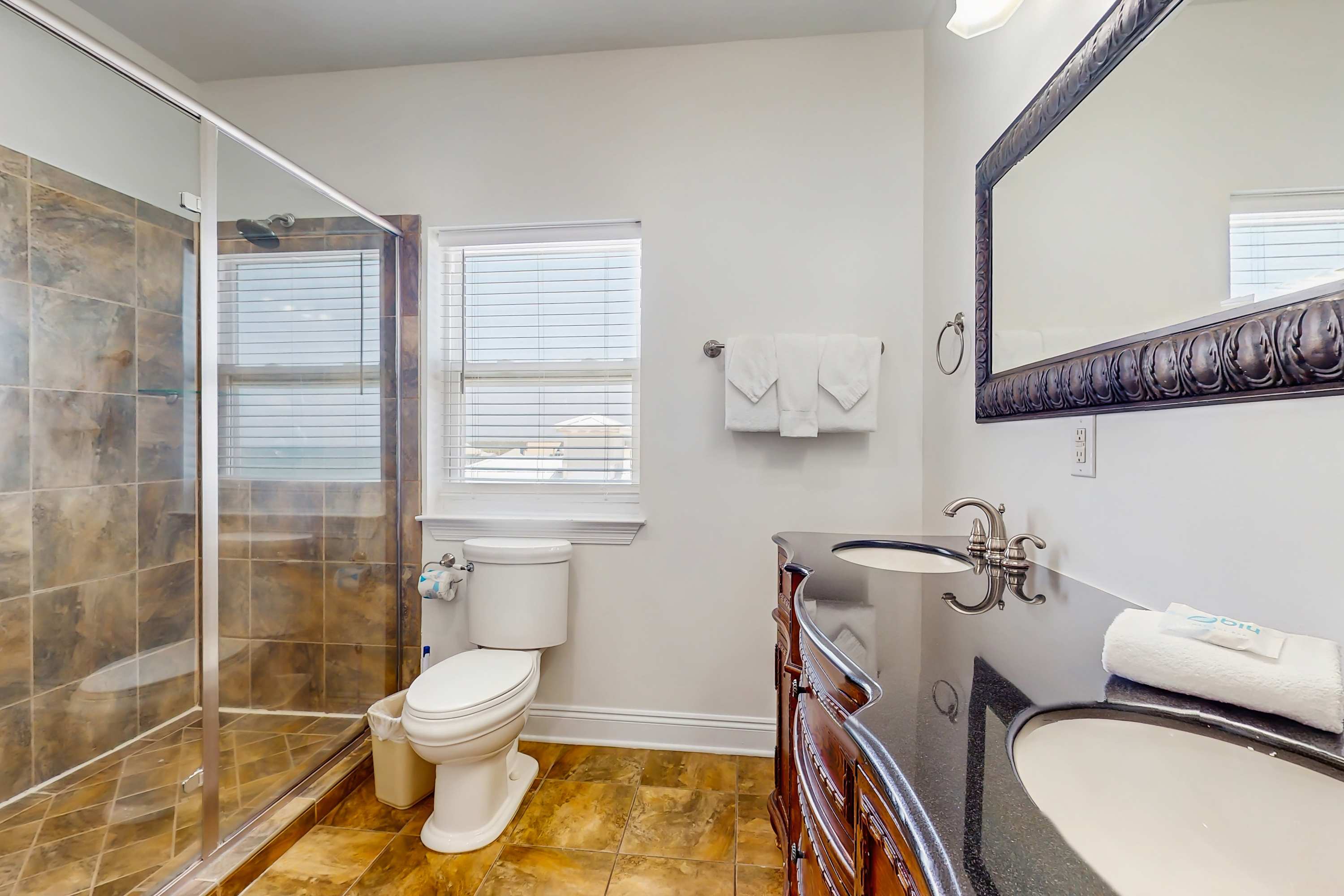 3rd floor en suite bathroom with dual shower heads, a double sink vanity, and gorgeous natural lighting