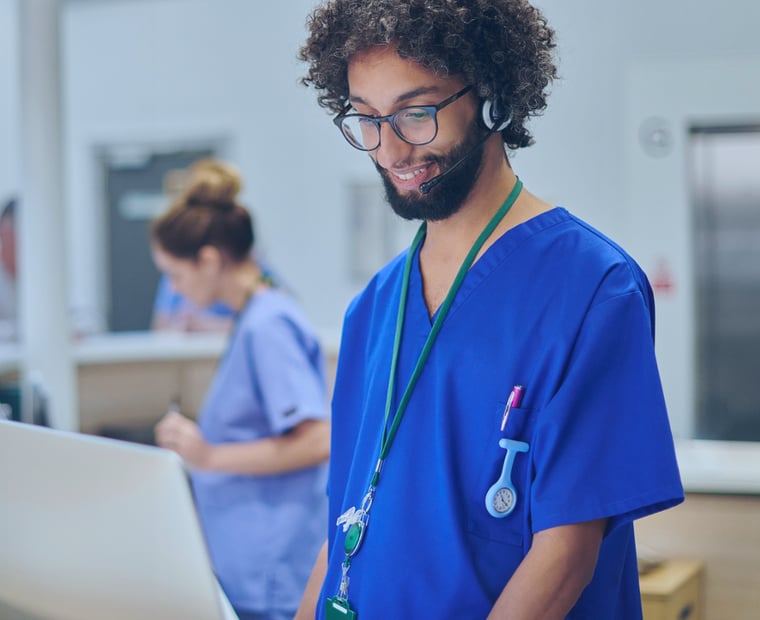 Doctor reviewing data on a computer enabled by process transformation following the implementation of a ServiceNow solution.