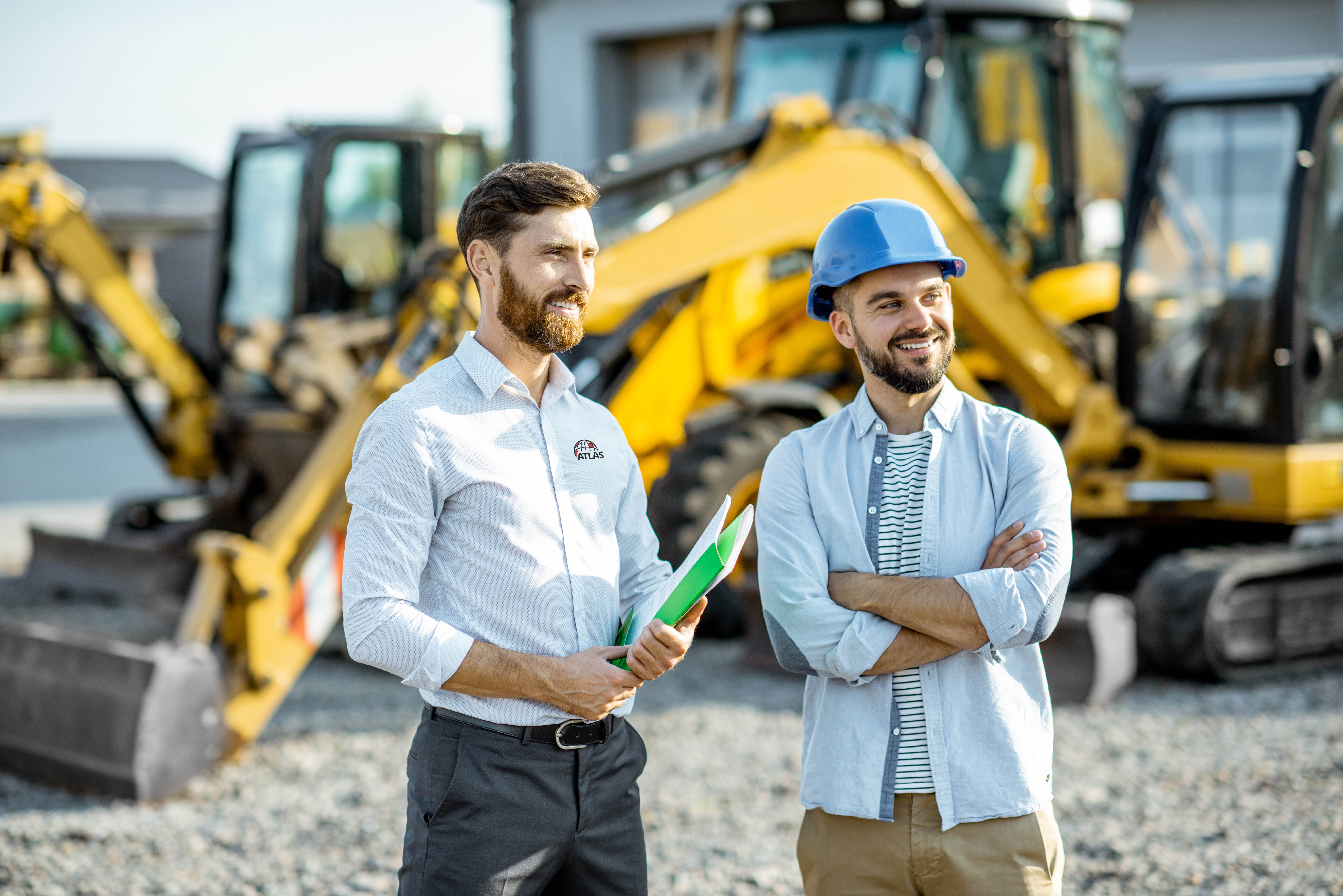 Atlas representatives discussing building insulation solutions at a construction site.