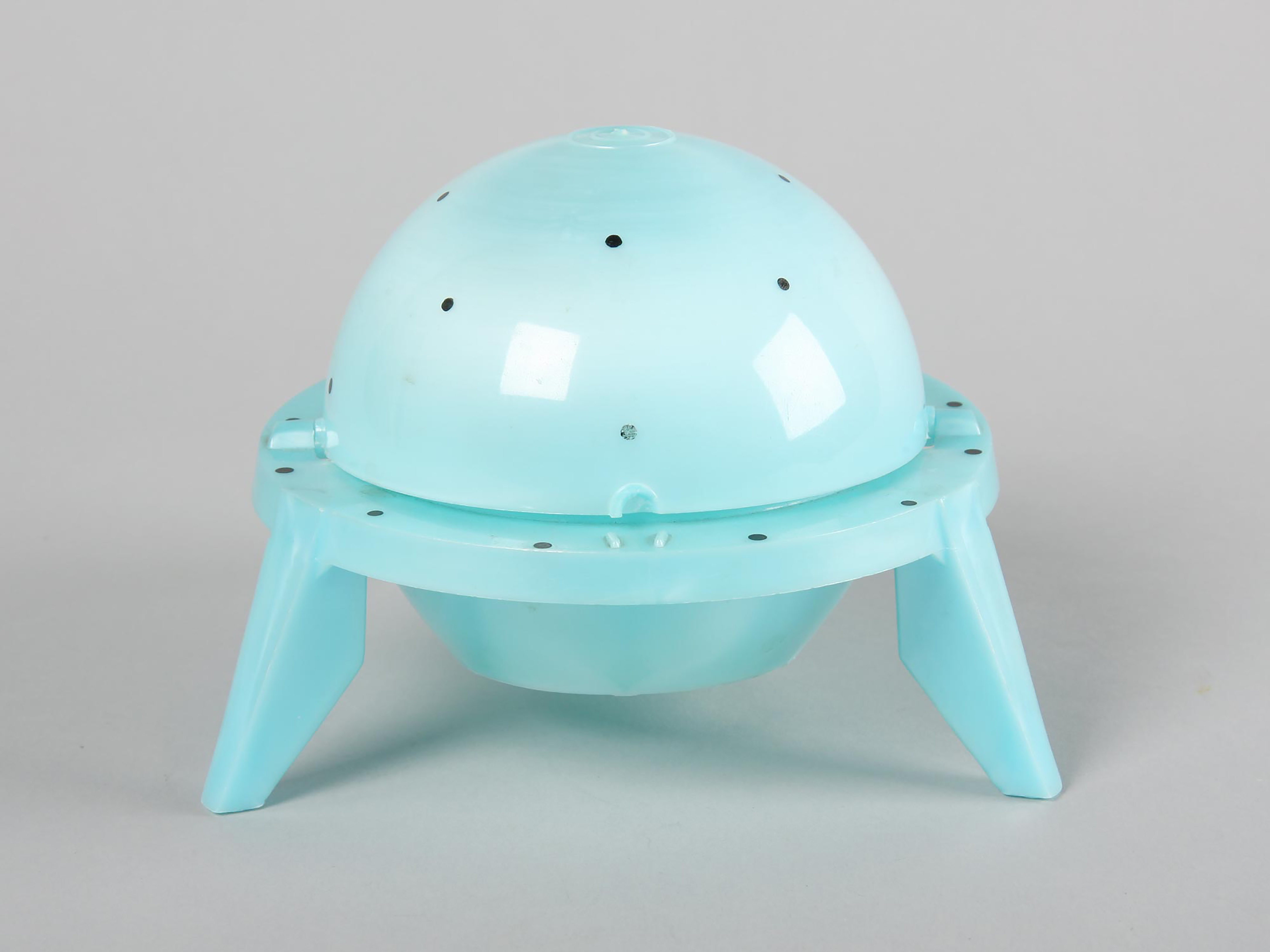 A blue plastic UFO toy.