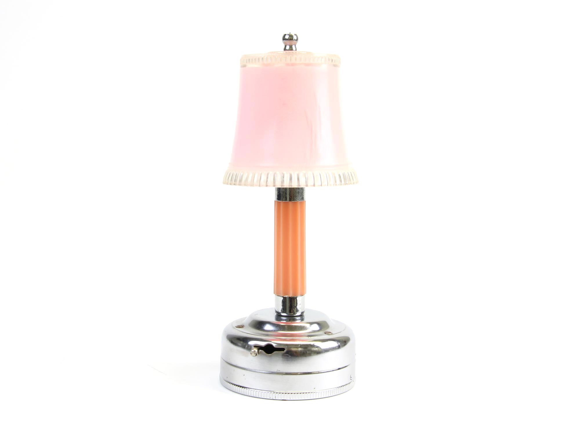 A small vintage table lamp with a pink shade and chrome base, shown on a white background.