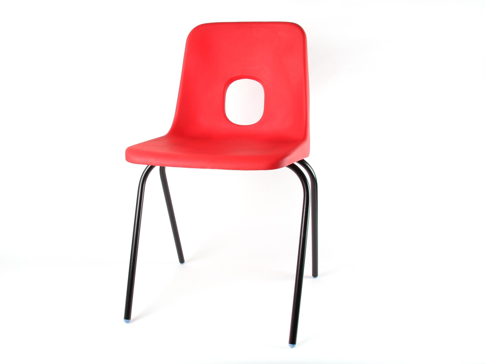 Red plastic chair with oval cutout in backrest on four black metal legs against white background.