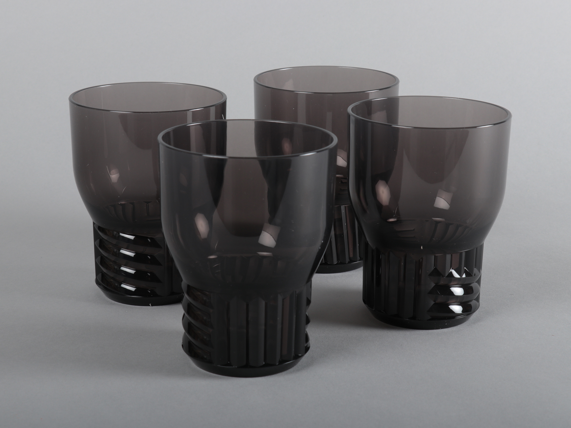 A set of four black drinking glasses.