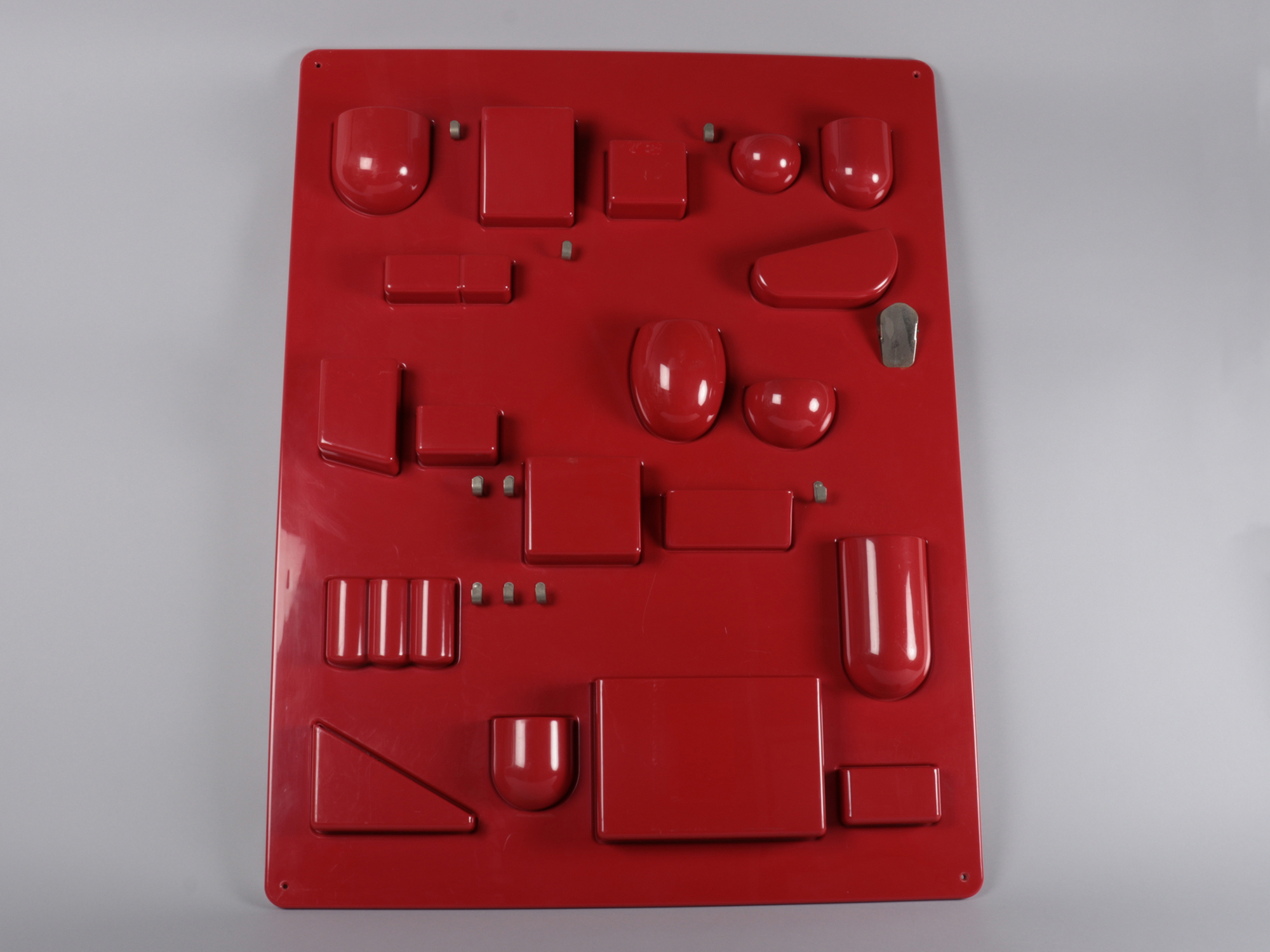 Red abstract game-like object on a plain background.