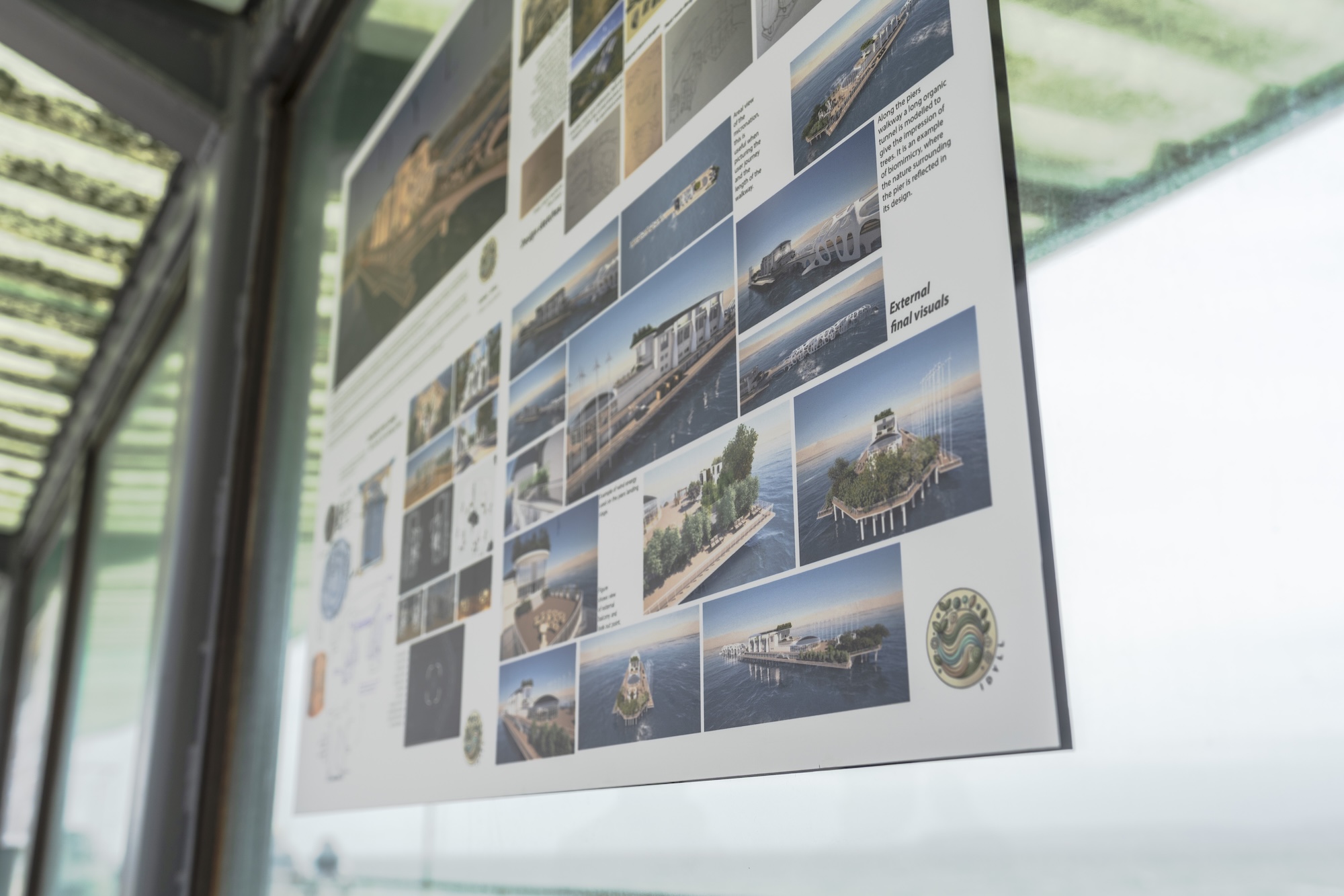 A poster on display as part of the Design for a Micronation exhibition at Bournemouth Pier, showing several exterior designs and mock-ups of Bournemouth Pier as a micronation.