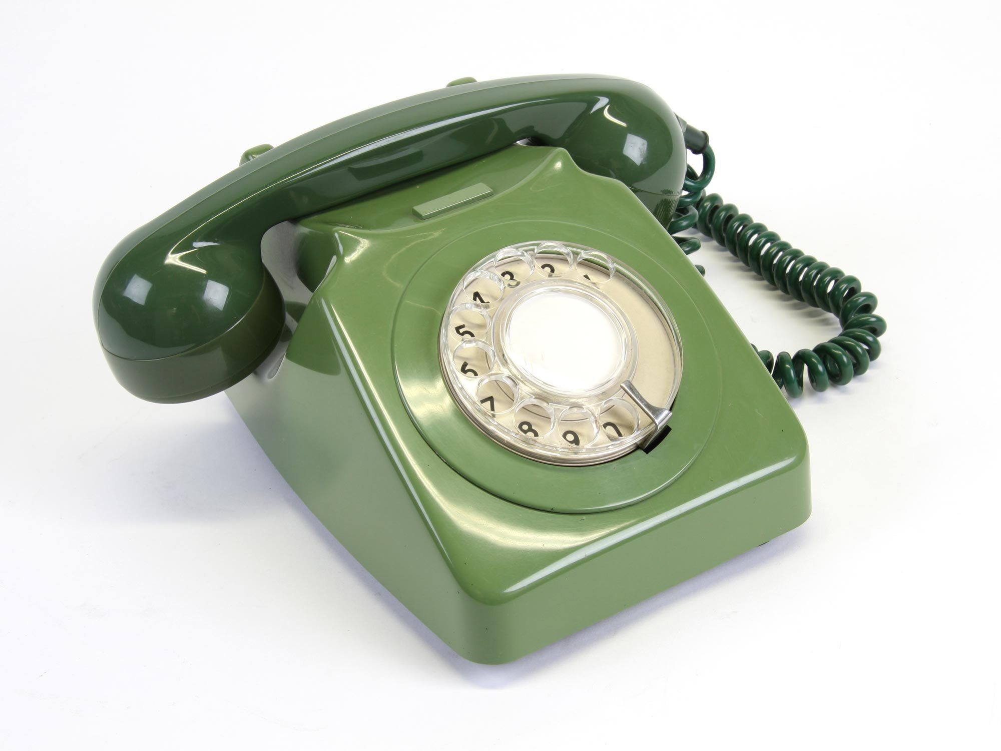 Green rotary telephone with circular dial featuring numbers and letters, coiled black cord, on white background.