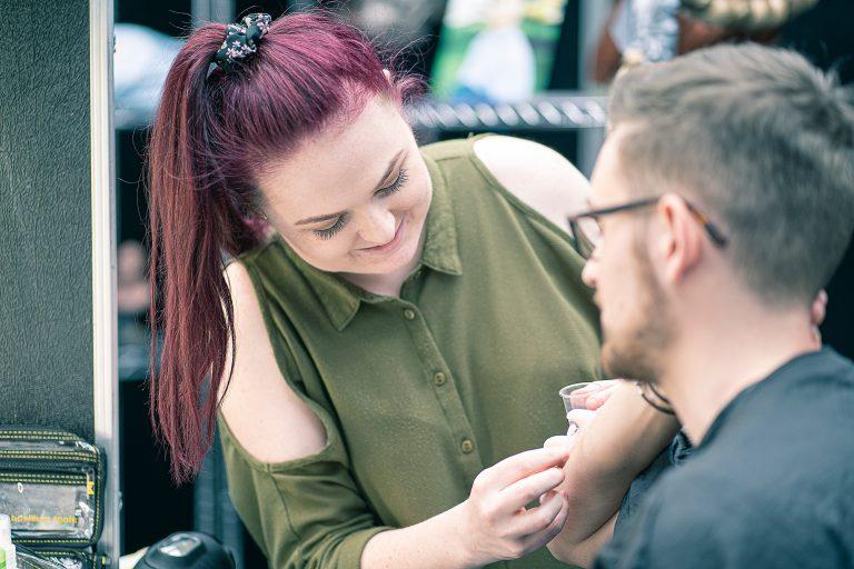 Danielle applying prosthetics to her model at the IMATS