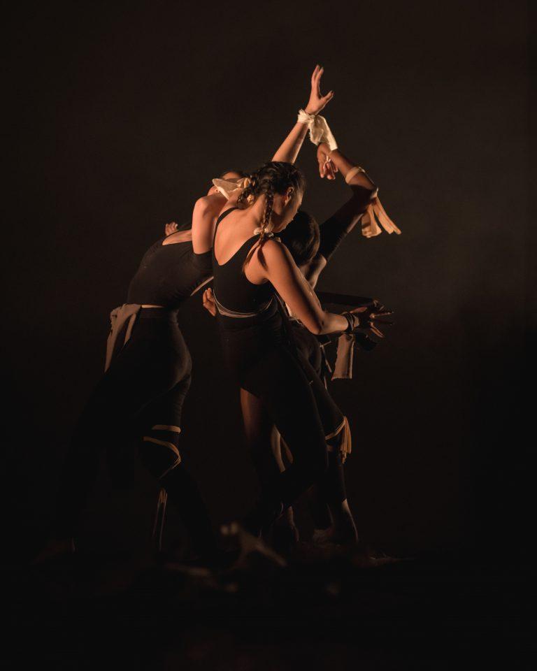 A number of dancers performing on stage in the middle of a routine