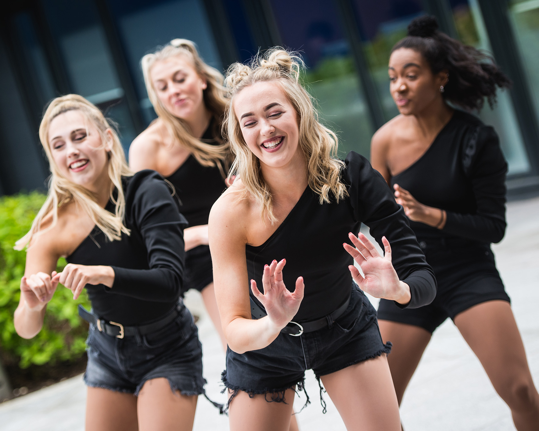Four BA (Hons) Dance students performing a routine in the courtyard on AUB campus.