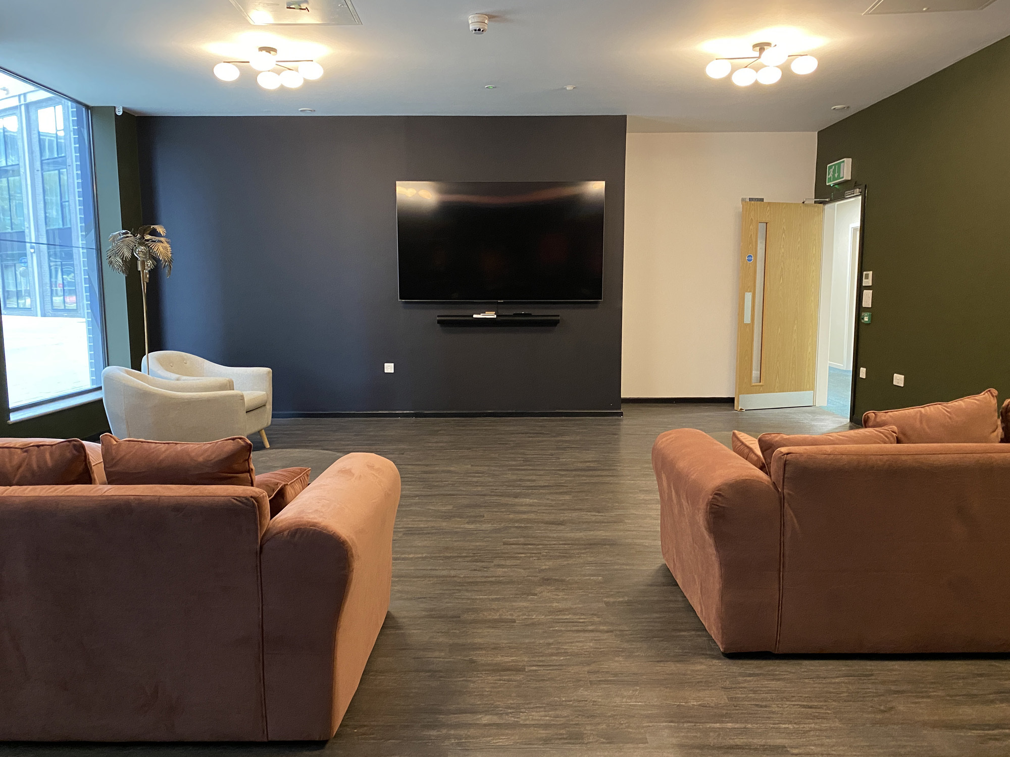 Cosy, orange sofas and a large TV at Home Park.