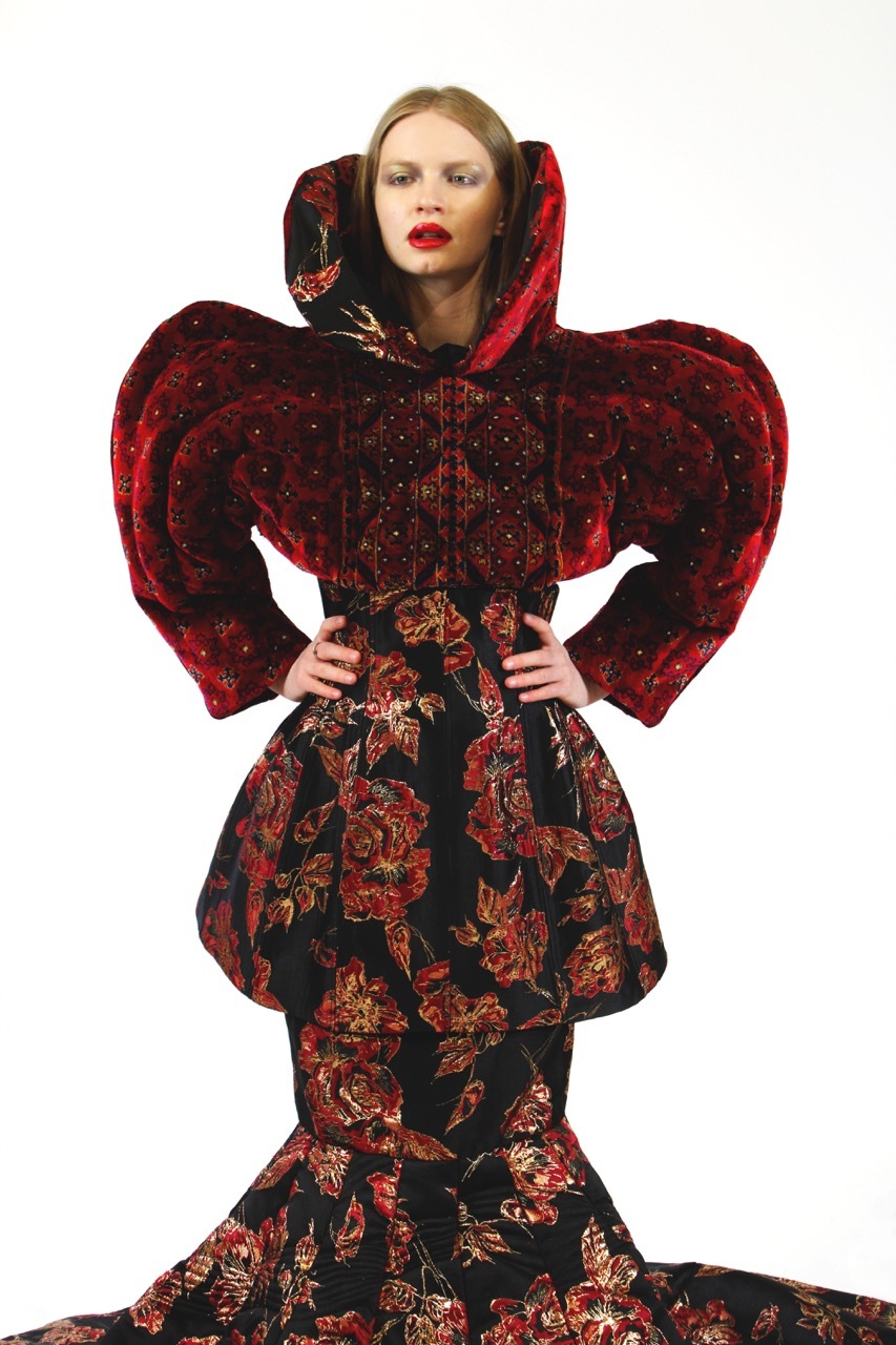 Floral and red velvet dress worn by a model, white background.