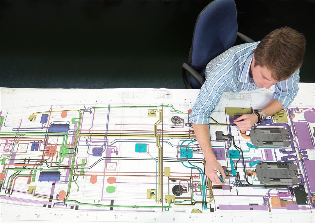 Sunseeker employee working on schematics of a boat