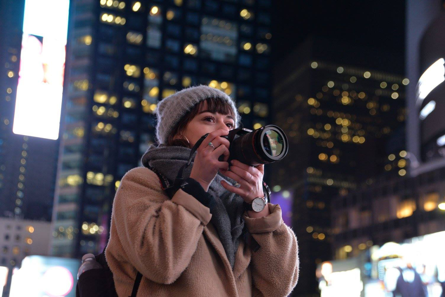 Woman with camera in city