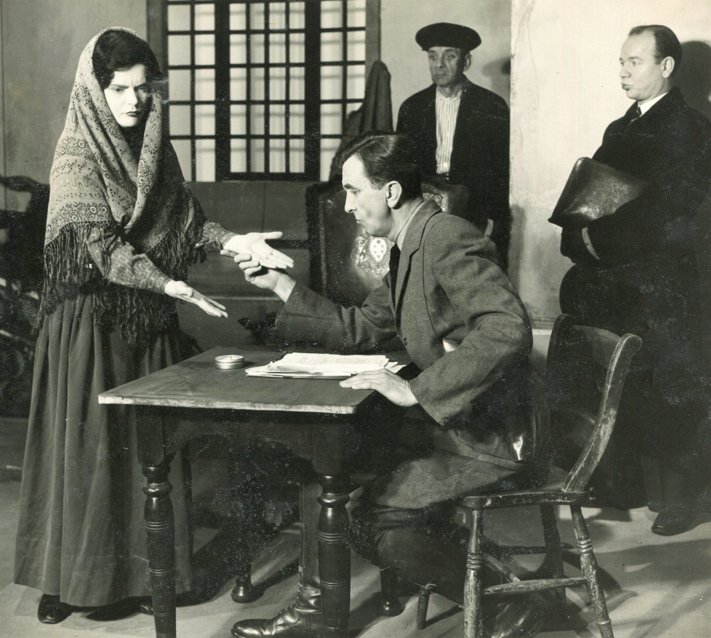 Black and white image of four actors on stage in "The Diary of Anne Frank" at Palace Court Theatre.