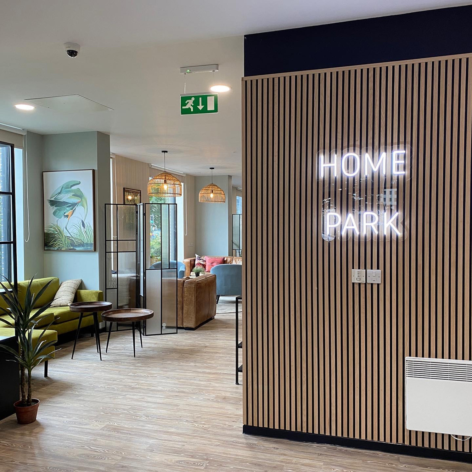 A wooden panel and lobby with 'HOME PARK' in white lights.