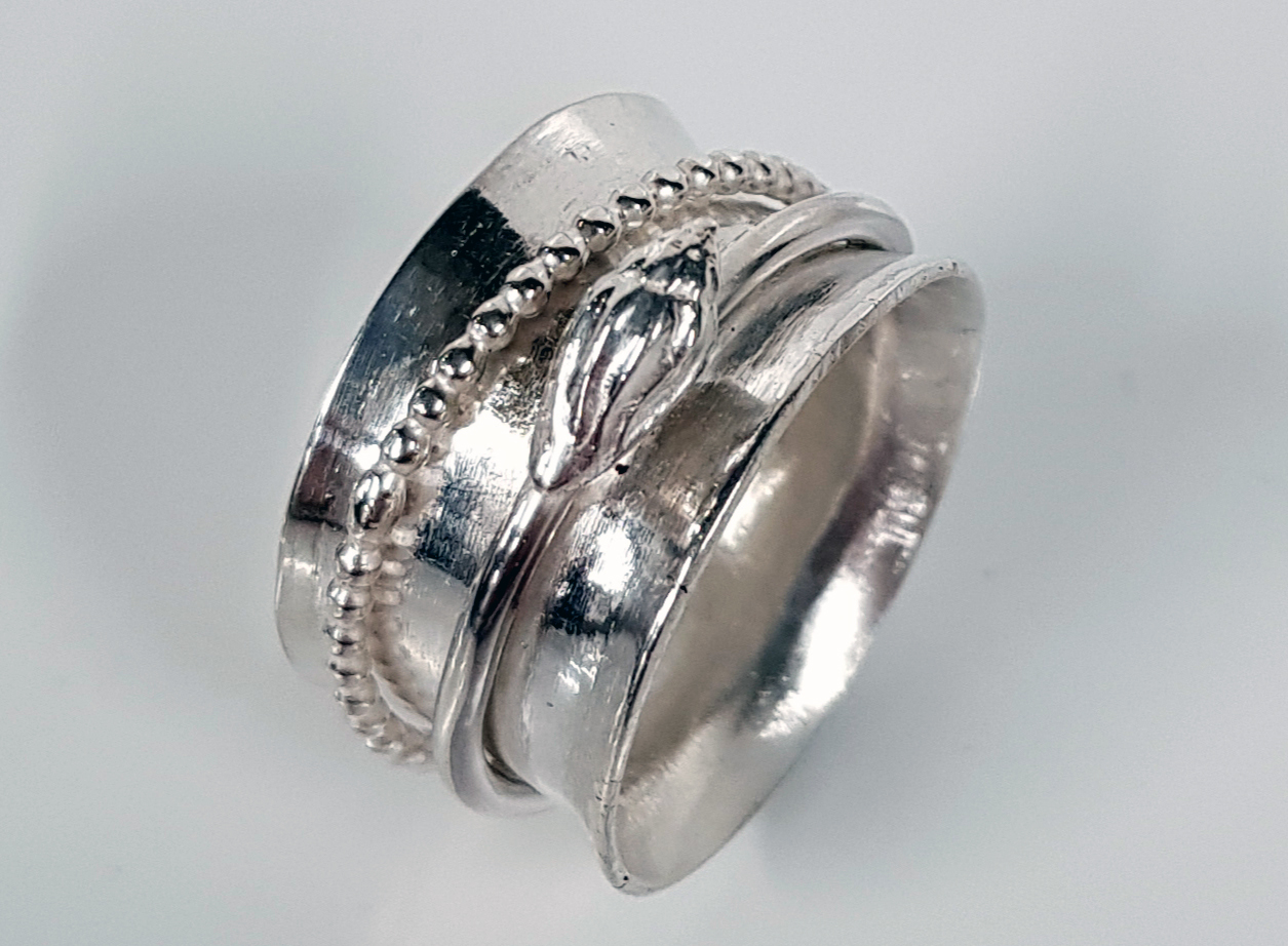 Silver ring designed with a snake wrapped around it.