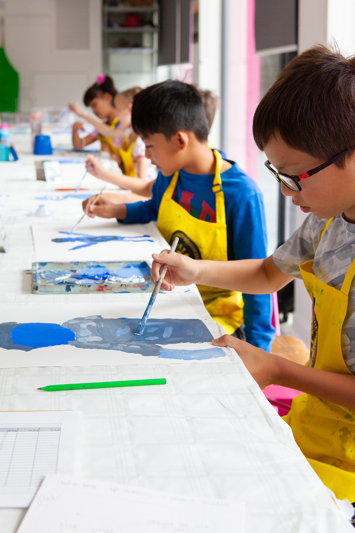 A group of young students painting