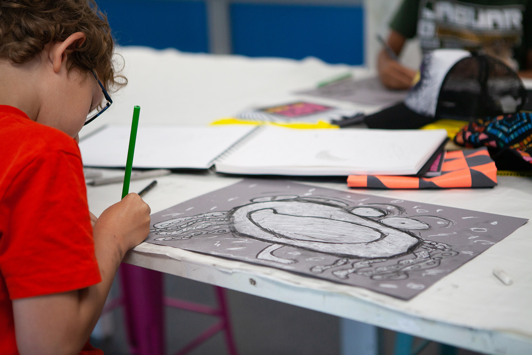 A young student is drawing